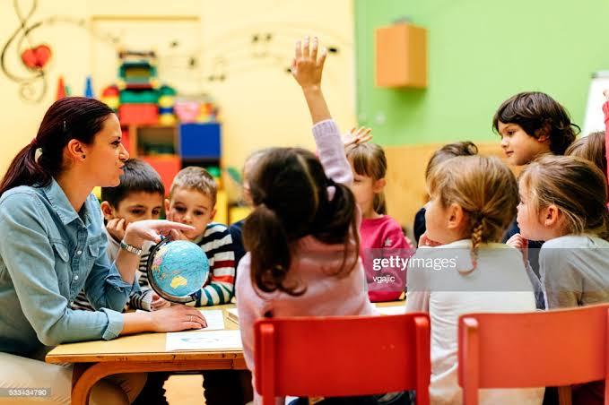 Children in-class learning and one pupil asks for permission to visit the washroom.