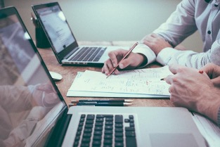  Person holding a pencil near a laptop computer by Scott Graham on Unsplash
